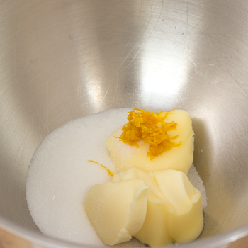 Margarine, sugar and orange zest in a bowl.