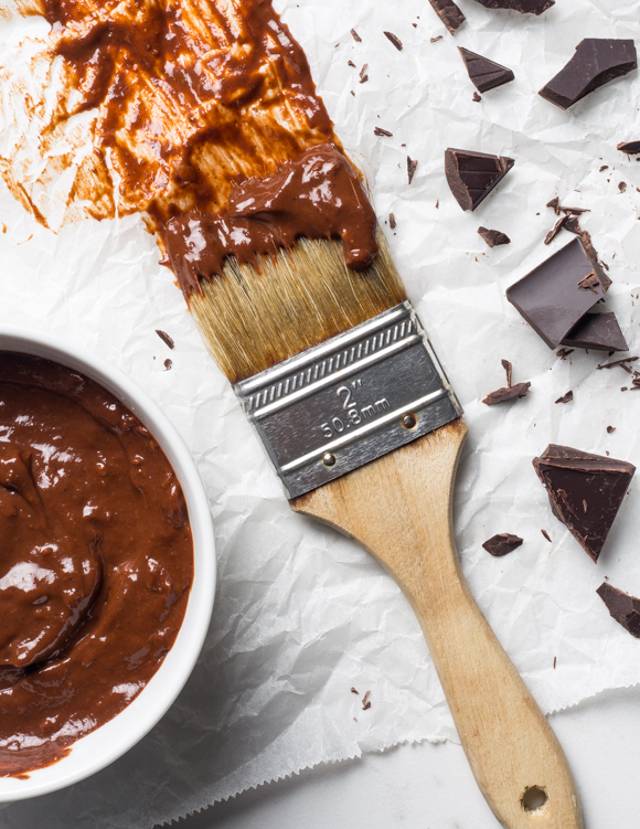Paintbrush with barbecue sauce and broken pieces of chocolate