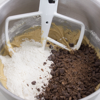 adding flour and chocolate chips